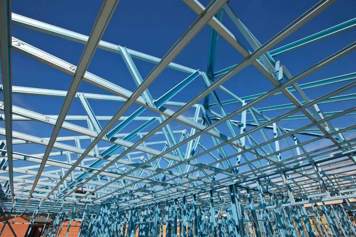 Industrial building construction frames over clear blue sky